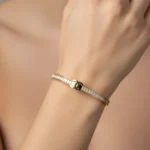 Gold Plated Bangle with Diamond-Like Stones & Logo | Trendy Jewel | Anti-Tarnish Jewellery for Women